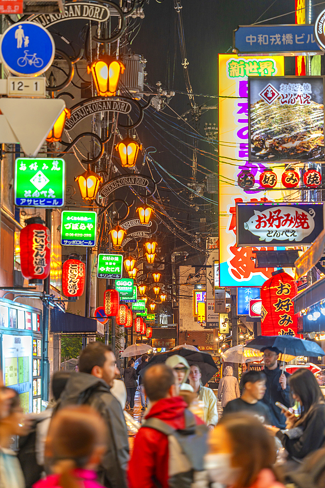 View of colourful signs in backstreet in Dotonbori, vibrant entertainment district near the river, Osaka, Honshu, Japan