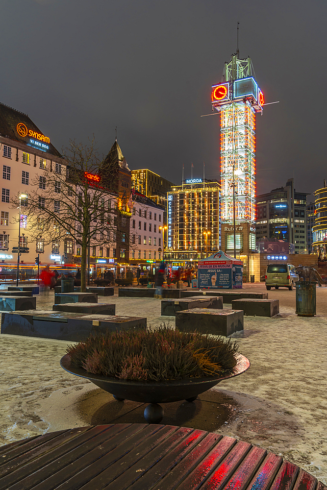 View of buildings and city tram in Jernbanetorget during winter at dusk, Oslo, Norway, Scandinavia, Europe