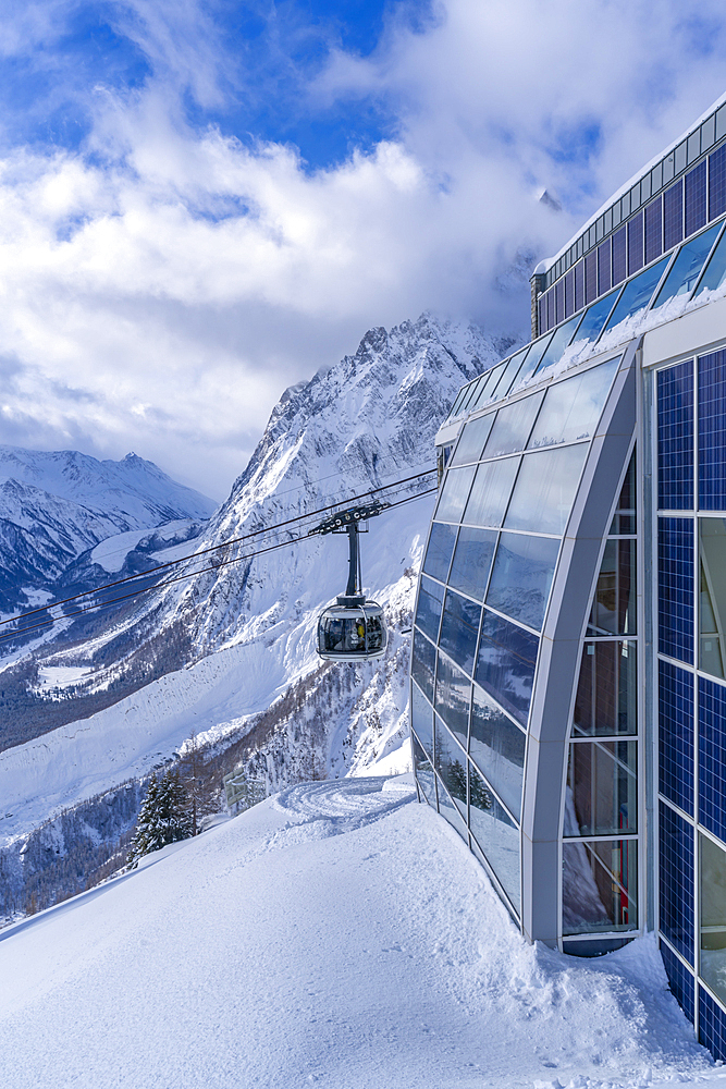 View of snow covered Aosta Valley, mountains and Skyway Monte Bianco cable car in winter, Courmayeur, Aosta Valley, Italy, Europe