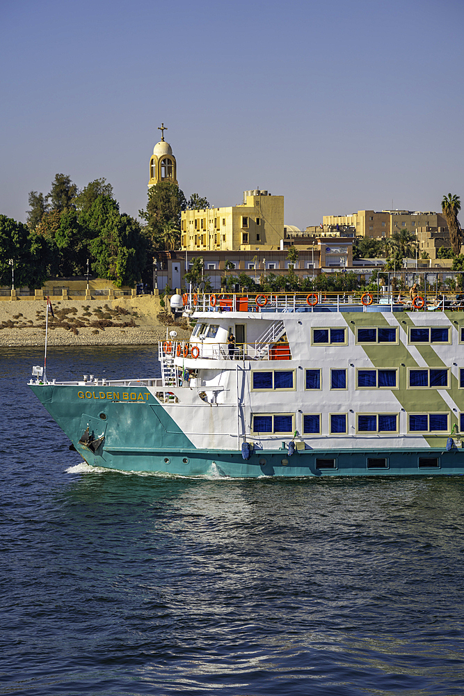 View of scenery and cruise boat from cruise boat near Armant on the Nile River, Luxor, Egypt, Africa
