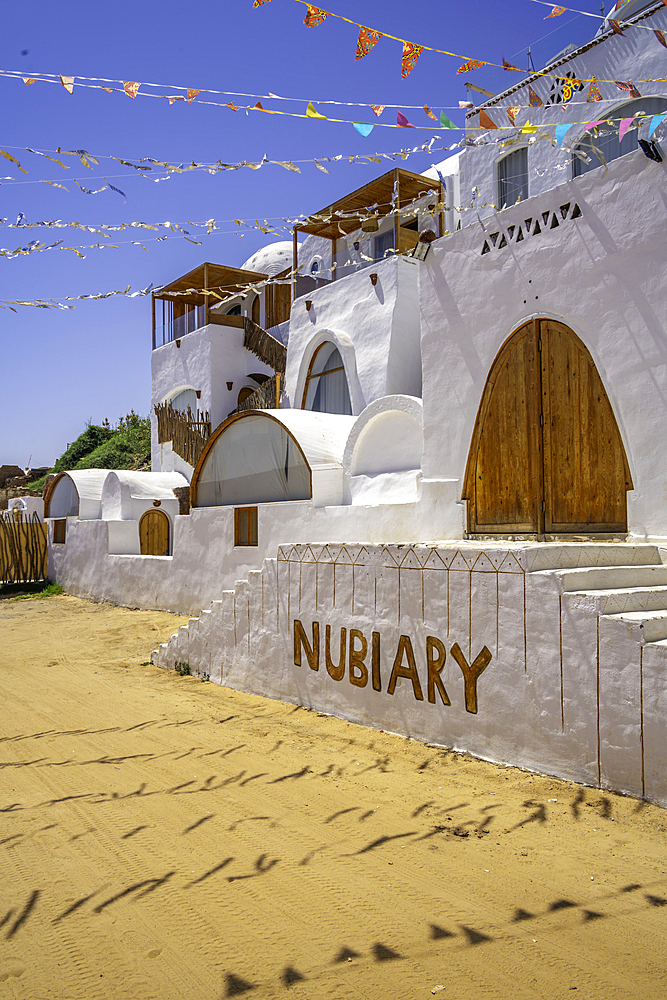 View of colourful architecture at Nagaa Suhayl Gharb on the Nile river near Aswan, Aswan, Nubia, Egypt, North Africa, Africa