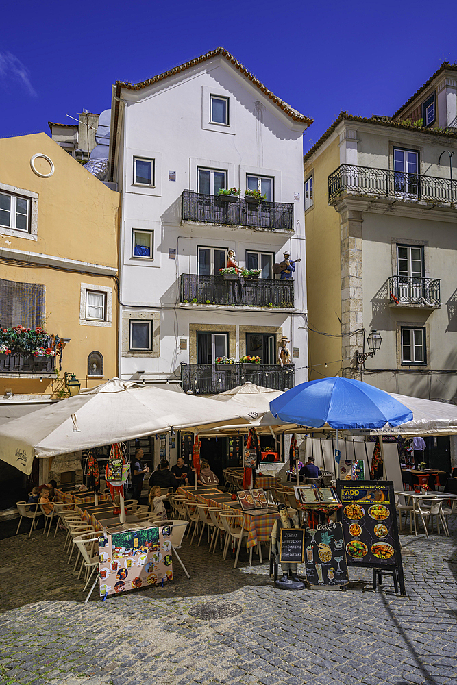 View of colourful buildings and cafe in the Alfama District on a sunny day, Lisbon, Portugal, Europe
