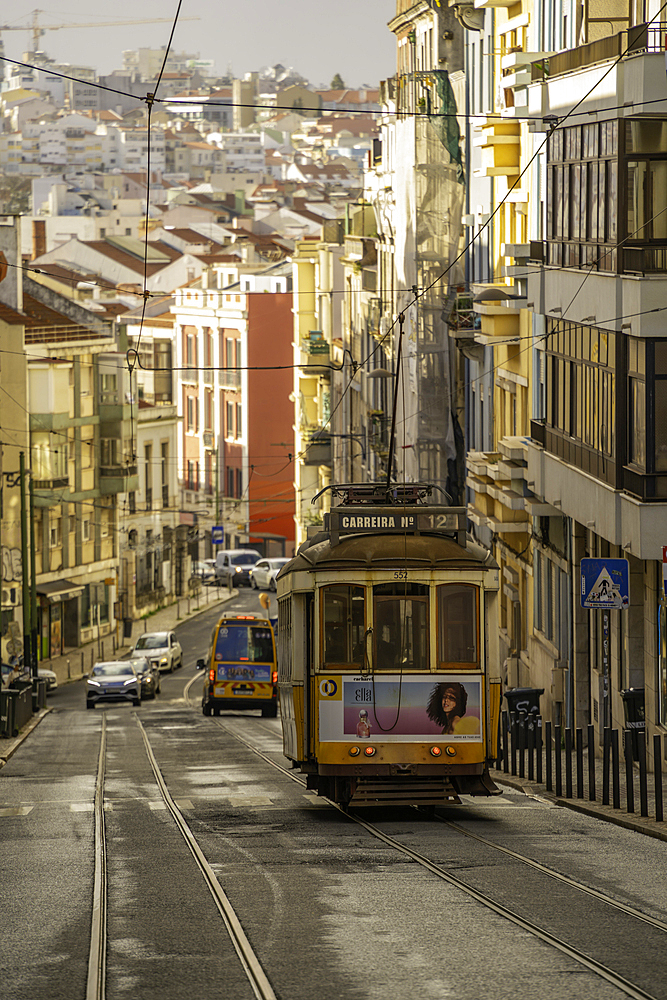 View of vintage tram and colourful buildings in the Alfama District on a sunny day, Lisbon, Portugal, Europe