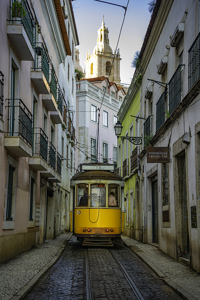 View of vintage tram and colourful buildings in the Alfama District on a sunny day, Lisbon, Portugal, Europe