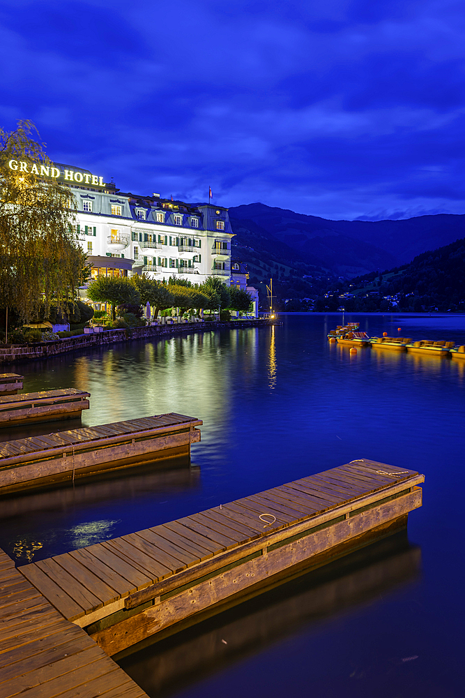 View of the Grand Hotel overlooking Lake Zell in Zell am See at dusk, Zell am See, Salzburg, Austria, Europe