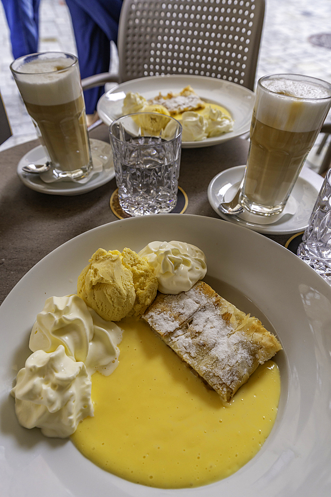 View of apple strudel and cream in the old town of Innsbruck, Innsbruck, Tyrol Region, Austria, Europe