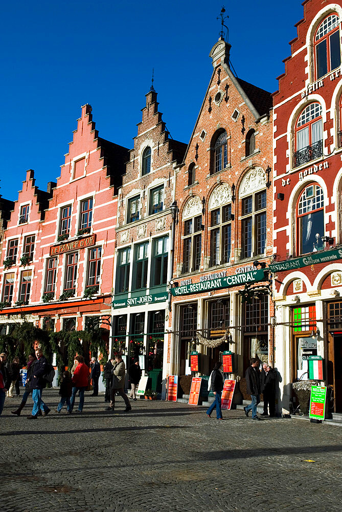 Gabled fronted restaurants in the Market Square at Christmas, Bruges, West Vlaanderen (Flanders), Belgium, Europe