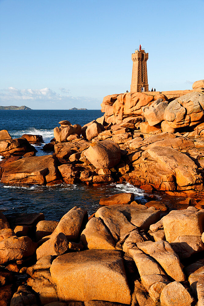 Lighthouse and pink rocks at sunset, Ploumanach, Cote de Granit Rose, Cotes d'Armor, Brittany, France, Europe