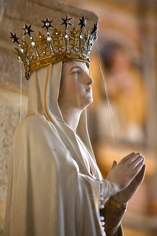 Statue of Virgin Mary wearing crown inside parish church, Saint-Thegonnec, Finistere, Brittany, France, Europe