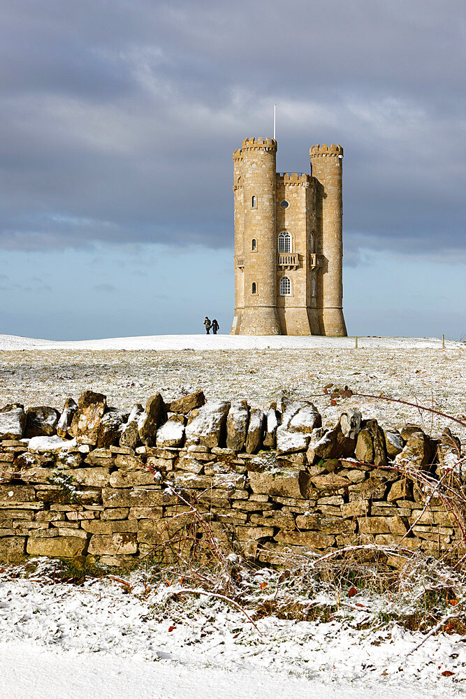 Broadway Tower and Cotswold drystone wall in snow, Broadway, Cotswolds, Worcestershire, England, United Kingdom, Europe