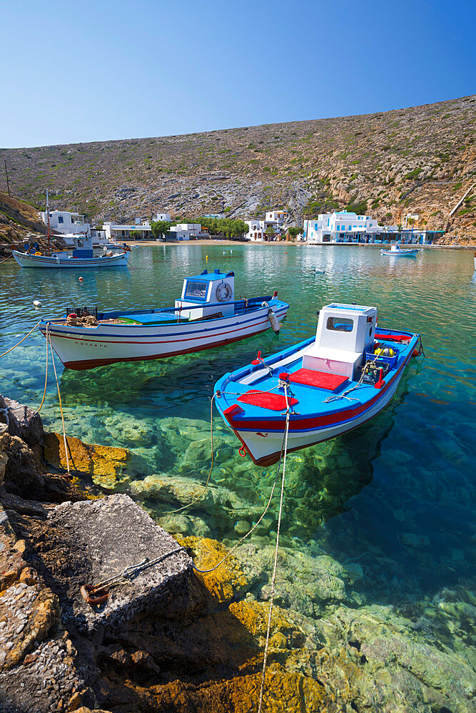 View over crystal clear water and fishing boats in harbour, Cheronissos, Sifnos, Cyclades, Aegean Sea, Greek Islands, Greece, Europe