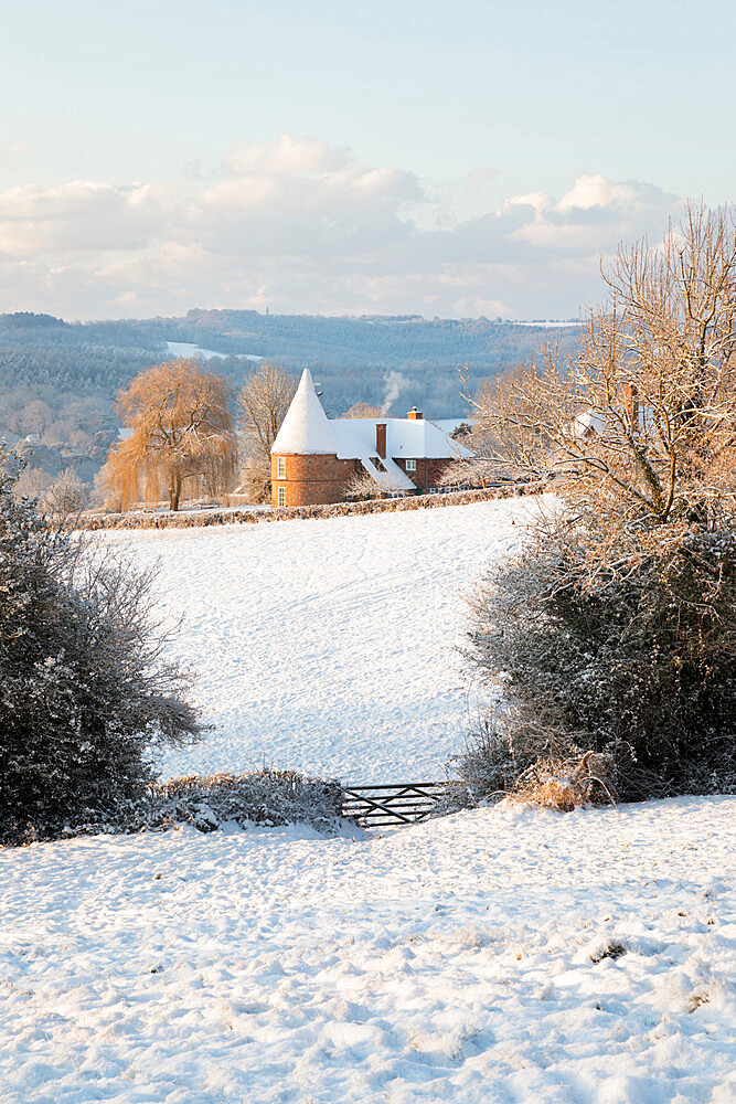 Former oast house in snow-covered High Weald landscape, Burwash, East Sussex, England, United Kingdom, Europe