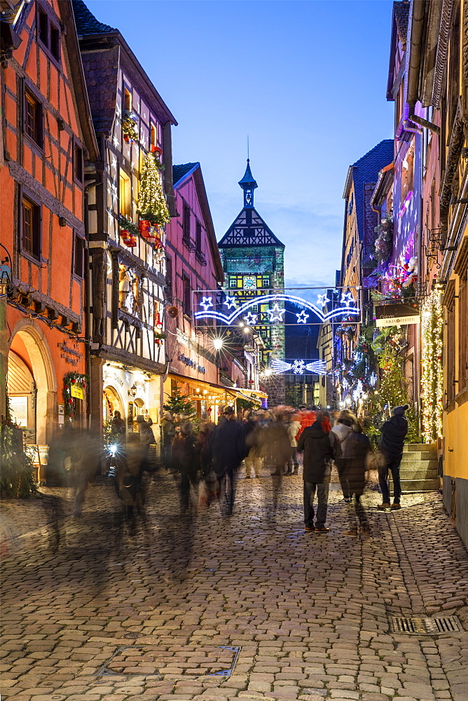 Rue du General de Gaulle covered in Christmas decorations illuminated at night, Riquewihr, Alsace, France, Europe