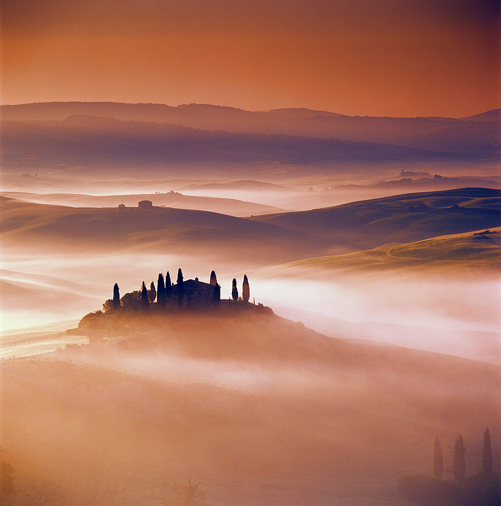 Tuscan farmhouse with cypress trees in misty landscape at sunrise, San Quirico d'Orcia, Siena Province, Tuscany, Italy, Europe