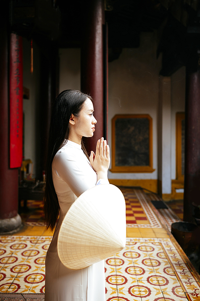 Vietnamese woman in ao dai at Quang Cong Temple, Hoi An, Quảng Nam Province, Vietnam