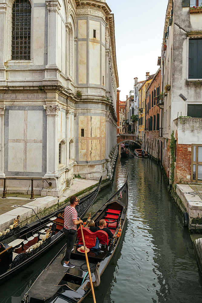 Gondola taking tourists along canals, Castello, Venice, Veneto, Italy