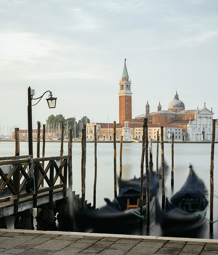 Goldolas on the lagoon at dawn, with San Giorgio Maggiore in the background, San Marco, Venice, Italy