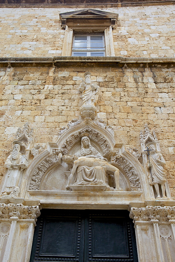 Statue of Our Lady of Sorrow and St. John the Baptist on the portal of the Franciscan church, Dubrovnik. Croatia, Europe