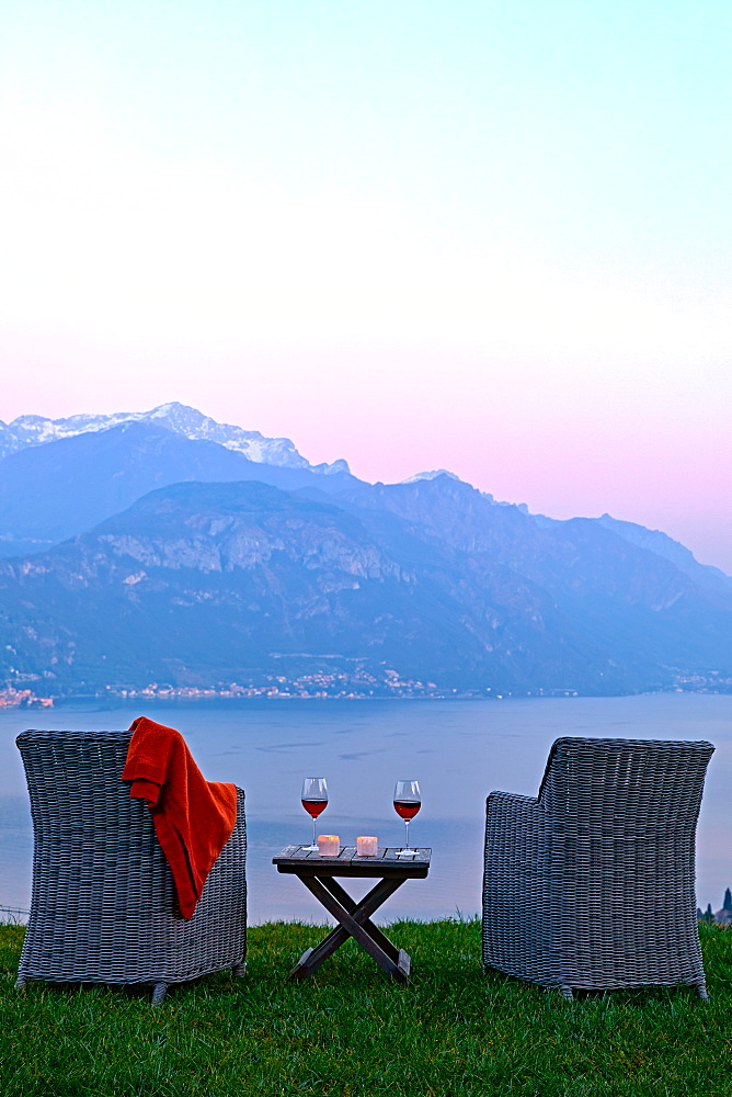 Armchairs and red wine with views of Lake Como at sunset, Lombardy, Italian Lakes, Italy, Europe