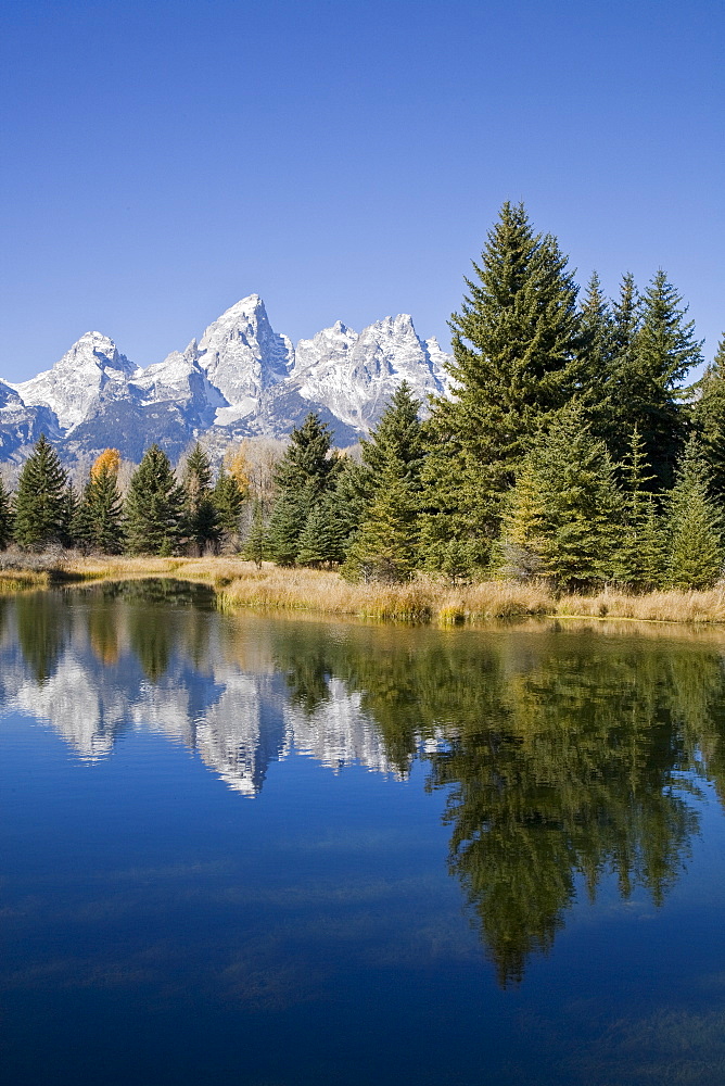 Reflected light on water from the Grand Teton Mountain Range, outside of Jackson Hole, Wyoming. This image was shot from the Schabawacker Landing on the snake river.