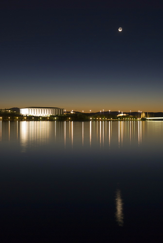 New moon above Australian National Library and Lake Burley Griffin, Canberra, Australian Capital Territory, Australia