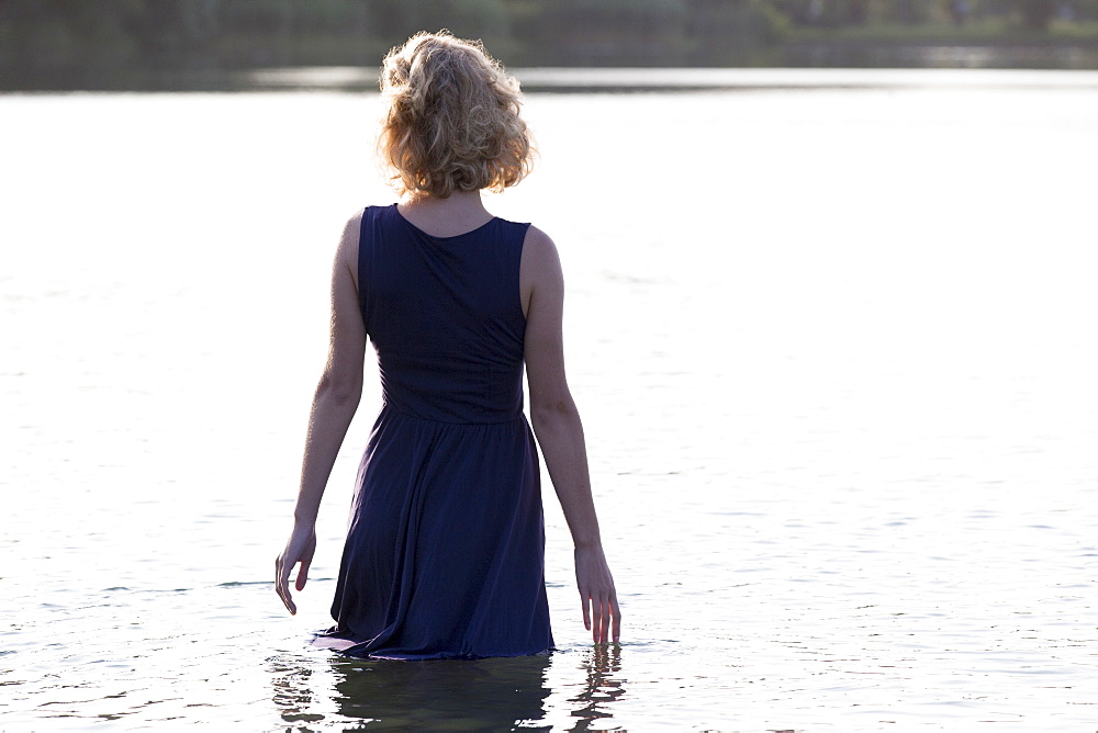 Beautiful woman standing in lake