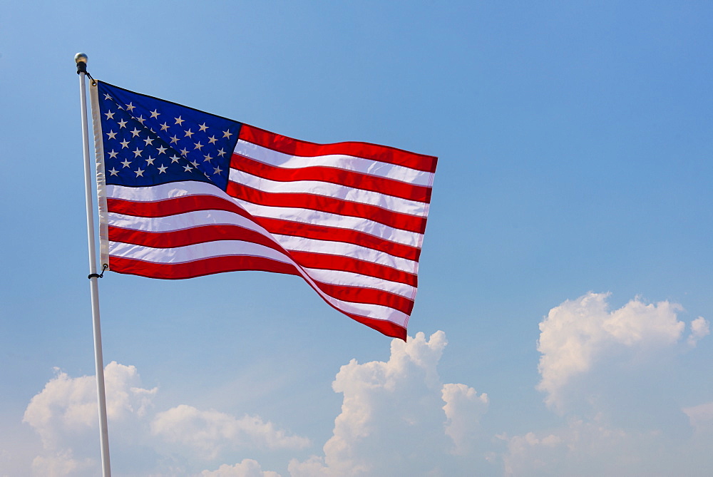 US flag against blue sky