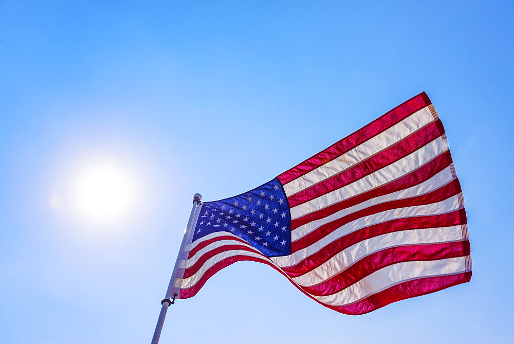 US flag against blue sky