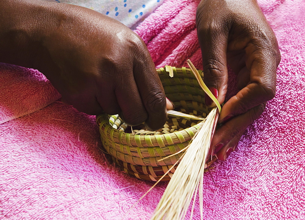 USA, South Carolina, Charleston, Hands of worker weaving sweetgrass