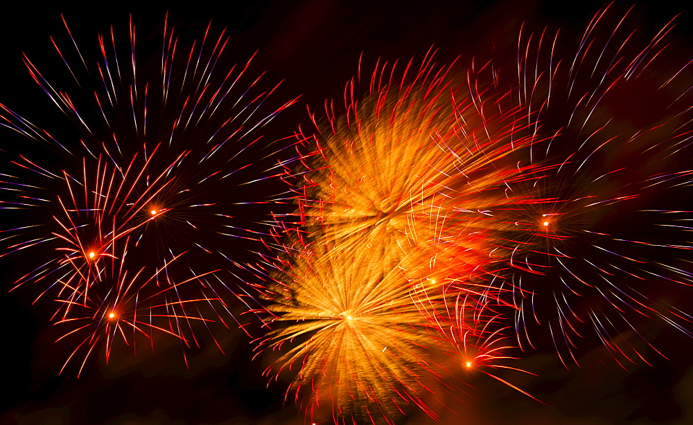 Fireworks explosion against night sky