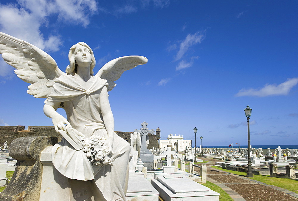 Puerto Rico, Old San Juan, Santa Maria Magdalena Cemetery with El Morro Fortress in background 