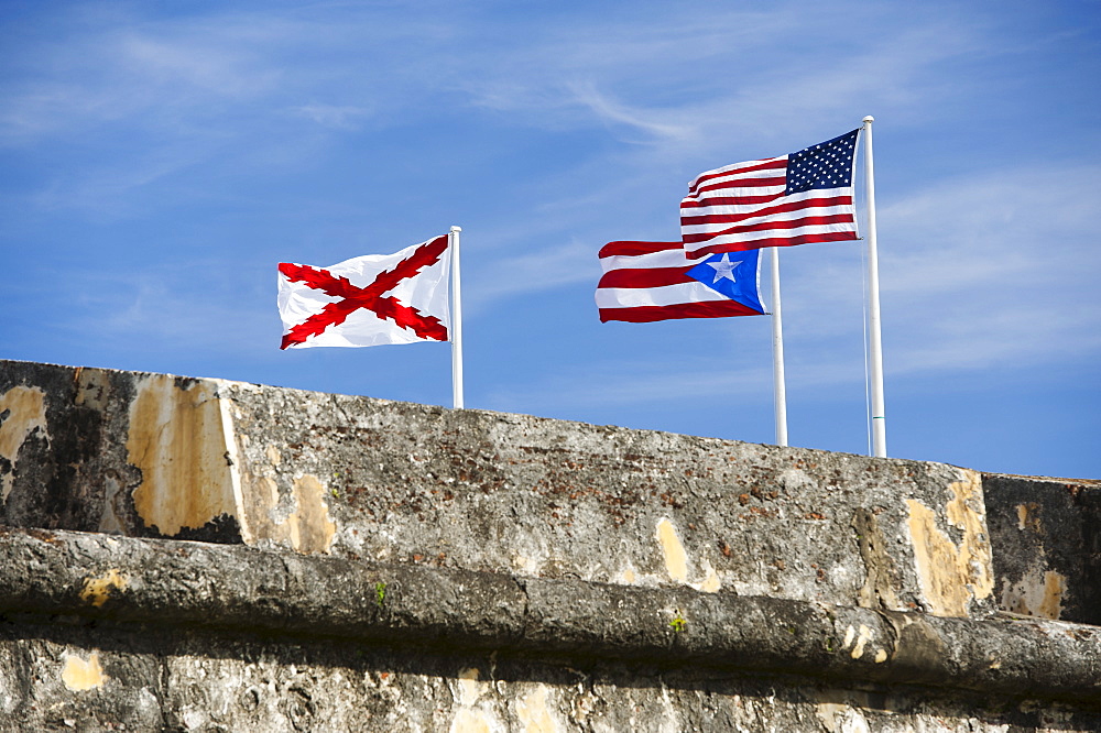 Puerto Rico, Old San Juan, El Morro Fortress, flags behind wall