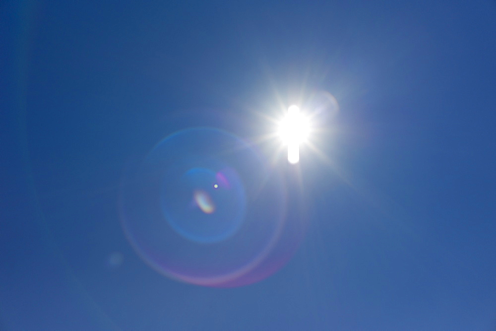 Flare of light in blue sky