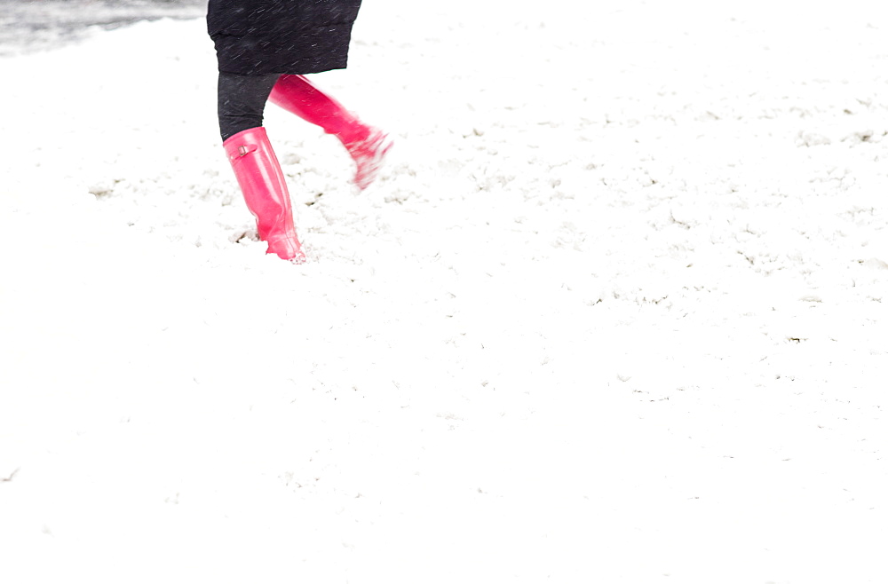 Low section of person dancing in snow, New York City, USA