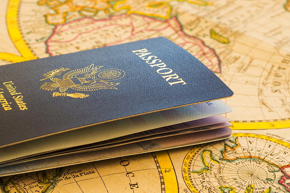 Passport sitting on antique map