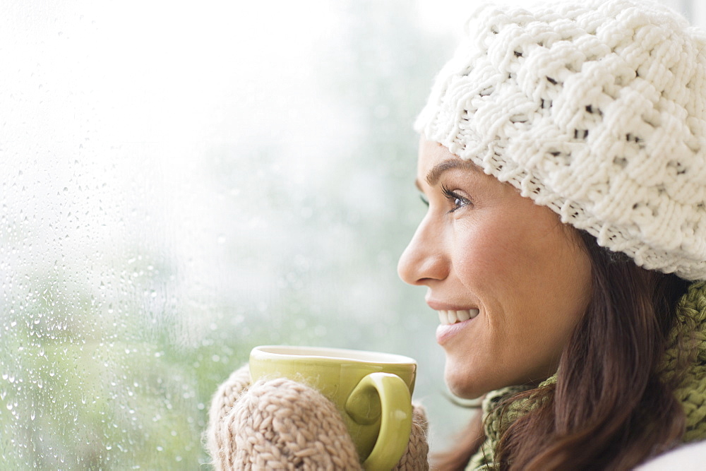 Woman in warm clothes holding mug