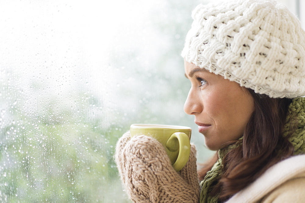 Woman in warm clothes holding mug