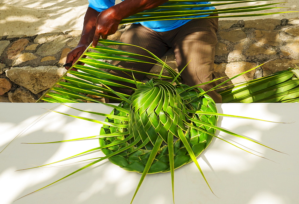 Man making hut with palm leaves, Jamaica