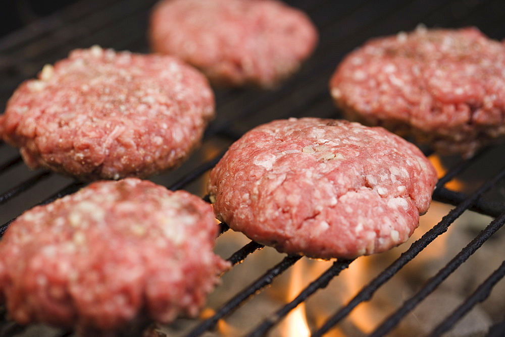 Hamburger patties cooking on grill