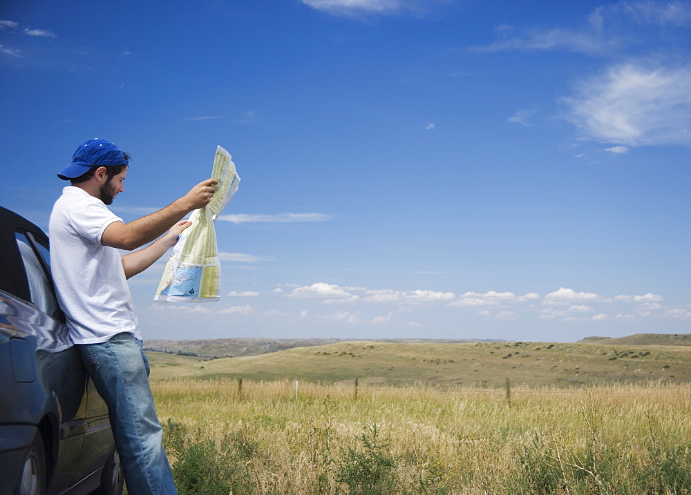 Man reading a map outdoors