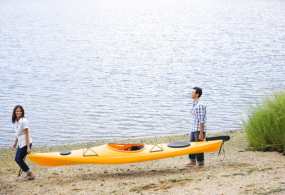 Couple carrying kayak