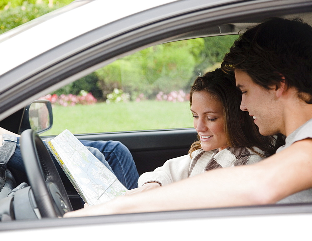 Couple in car looking at map