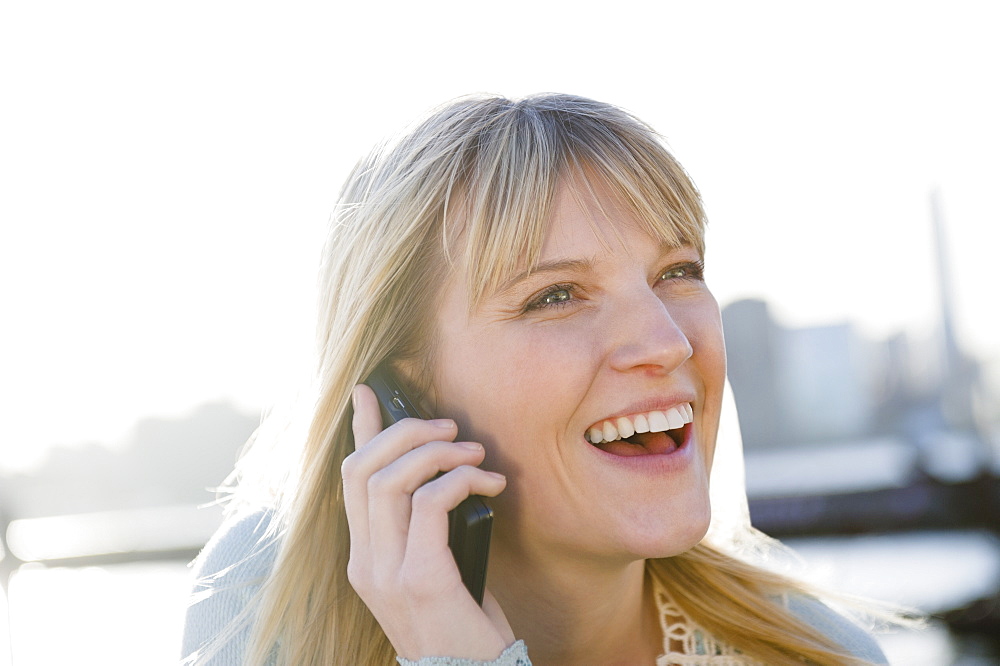 USA, Brooklyn, Williamsburg, Portrait of blonde woman talking on mobile phone