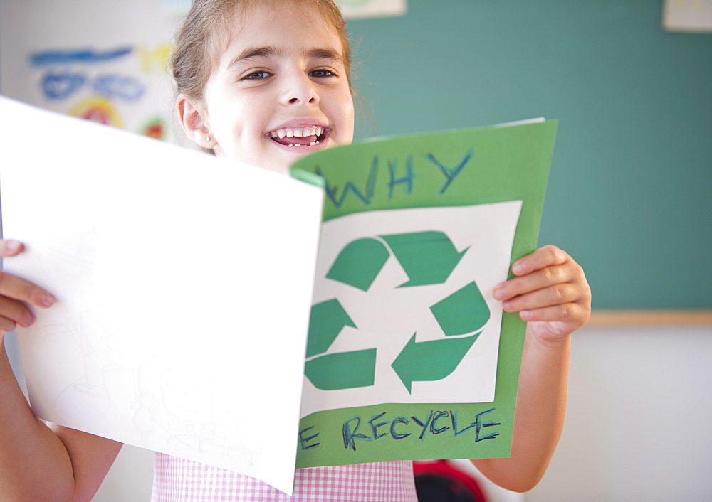 Portrait of schoolgirl ( 6-7) presenting environmental knowledge