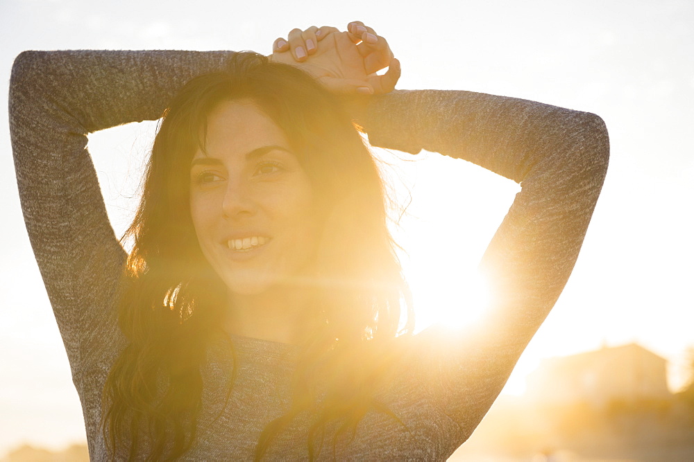 Smiling woman at sunset, Rockaway Beach, New York