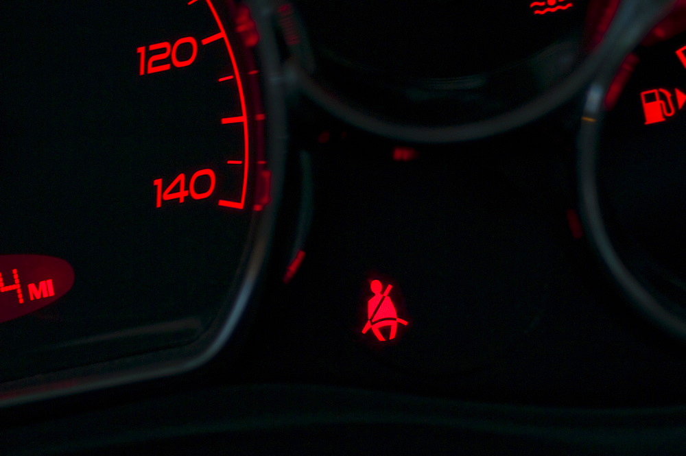 The seat belt warning on the dashboard of a car