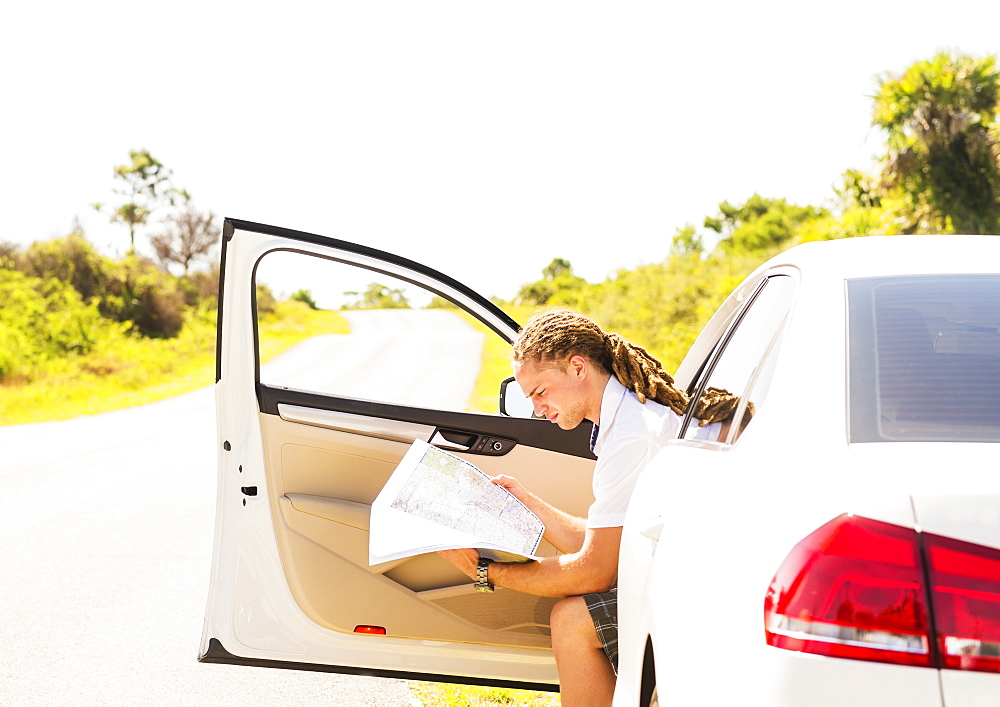 Young man checking map, Tequesta, Florida