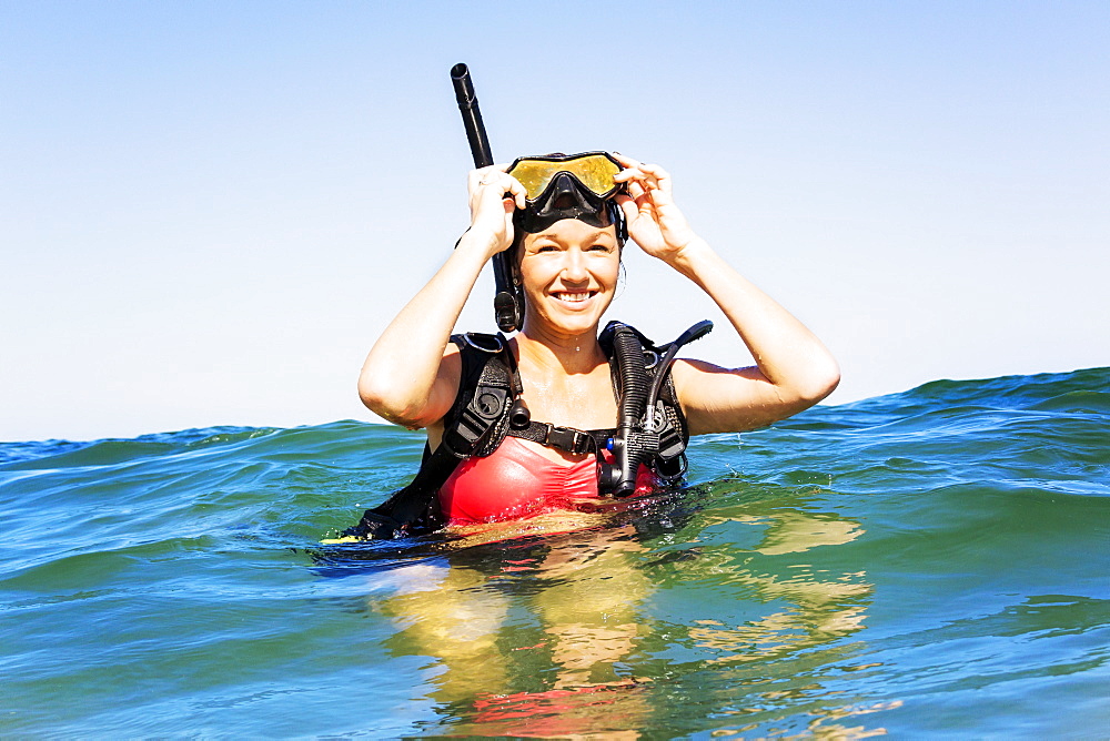 Portrait of young woman scuba-diving in sea, Jupiter, Florida