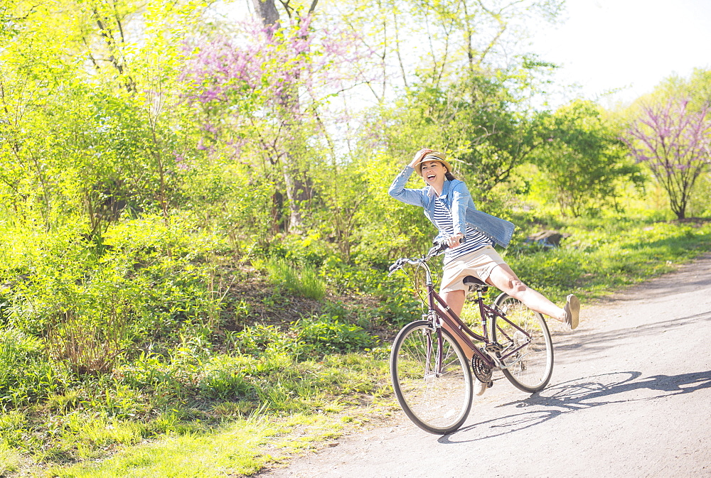 Mid adult woman riding bicycle, Central Park, New York City