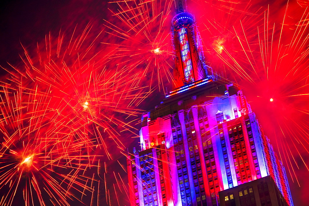 Empire state building with firework display, New York City, New York